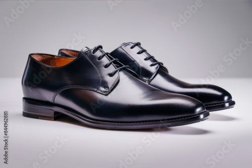 Elegant men's leather dress shoes with sleek design, captured against a minimalist background for a sophisticated look.. AI generated.