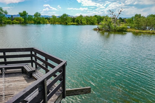 A view of the nesting island at Kountze Lake and surrounding trees and mountains from the viewing deck at Belmar Park in Lakewood, Colorado.