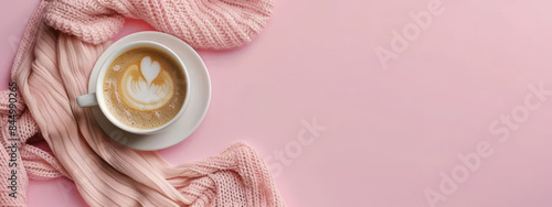 Coffee cup with textile blanket on pink background for banner. Hot drinks concept for banner. Flat lay, top view with copy space