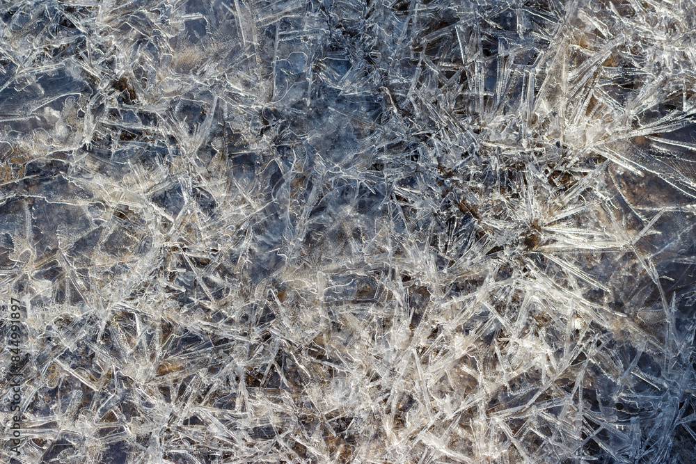 Background with growing ice on a pond in full frame Background with growing ice on a pond in full frame