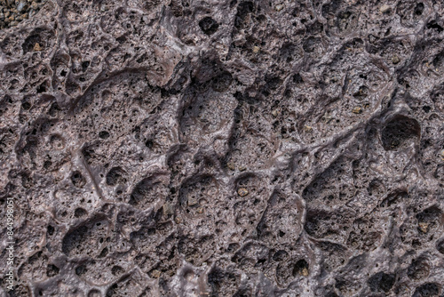 Vesicular texture is a volcanic rock texture characterized by a rock being pitted with many cavities (known as vesicles) at its surface and inside.  Hawaii Volcanoes National Park, 1969 Lava Flow 