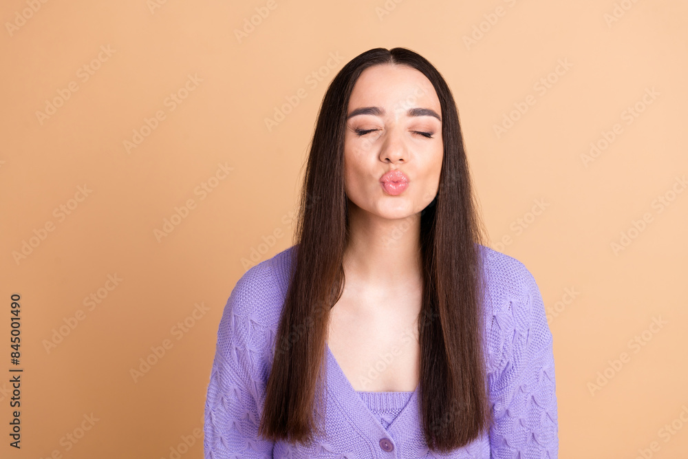 Obraz premium Portrait of nice young woman closed eyes kiss wear cardigan isolated on beige color background