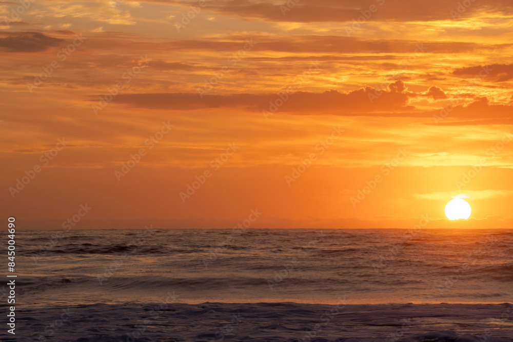 Sunrise at beach bright orange clouds background Sunrise at beach bright orange clouds background