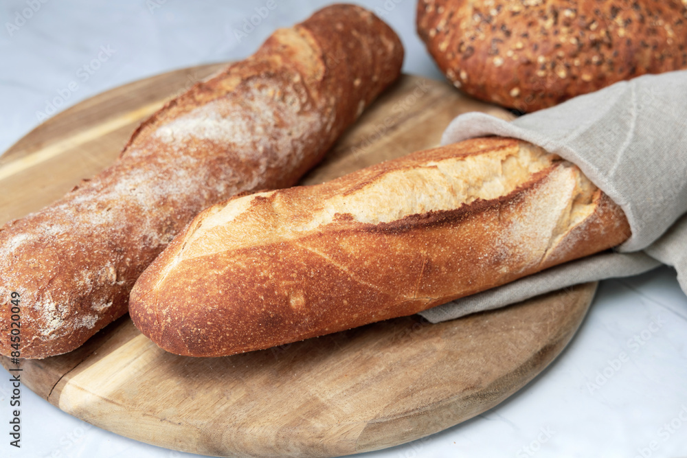 Two fresh baguettes on a cutting board. High quality photo Two fresh baguettes on a cutting board. High quality photo