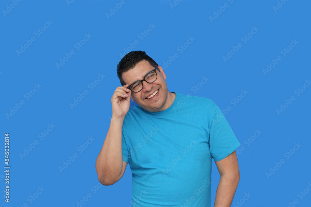 A 40-year-old dark-skinned Latino man uses eyeglasses to see better because he suffers from myopia and astigmatism in the vision of his eyes A 40-year-old dark-skinned Latino man uses eyeglasses to see better because he suffers from myopia and astigmatism in the vision of his eyes