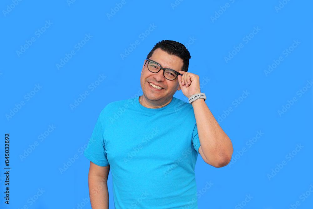 Fototapeta premium A 40-year-old dark-skinned Latino man uses eyeglasses to see better because he suffers from myopia and astigmatism in the vision of his eyes