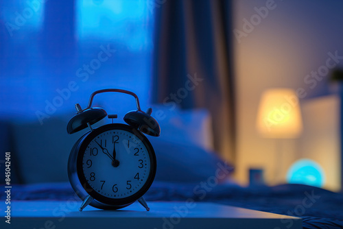 Alarm clock on the bedside table. It's time to sleep.