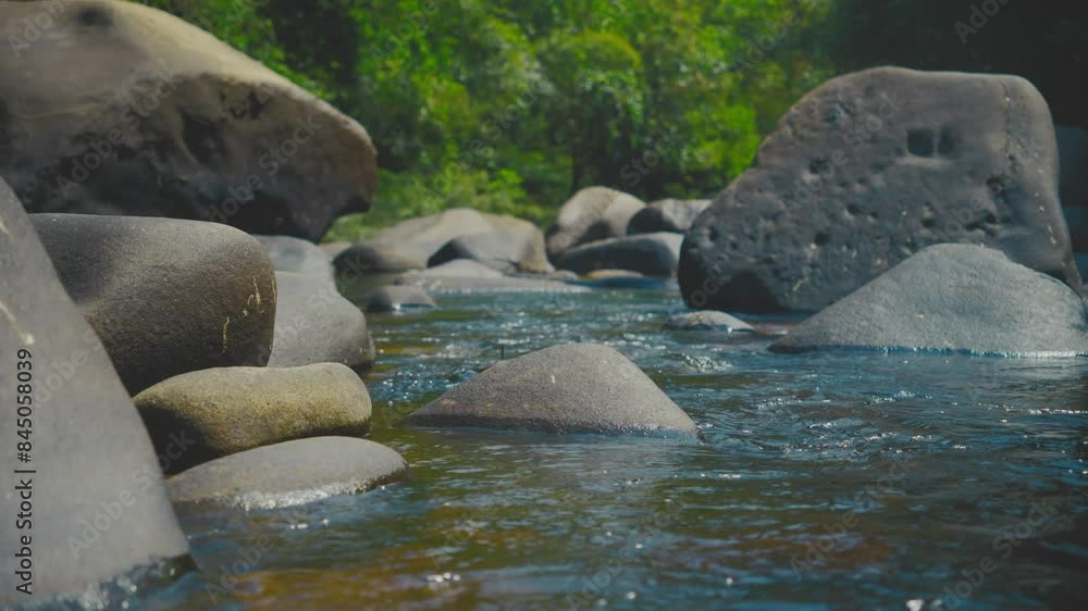 Peaceful river flows over smooth rocks in Khao Sok National Park, Thailand Peaceful river flows over smooth rocks in Khao Sok National Park, Thailand