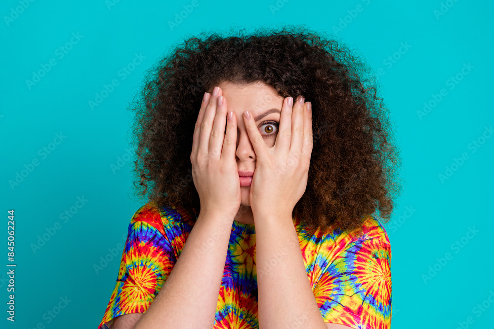 Photo of funny cute girl wear trendy vivid print clothes arms close face isolated on cyan color background Photo of funny cute girl wear trendy vivid print clothes arms close face isolated on cyan color background