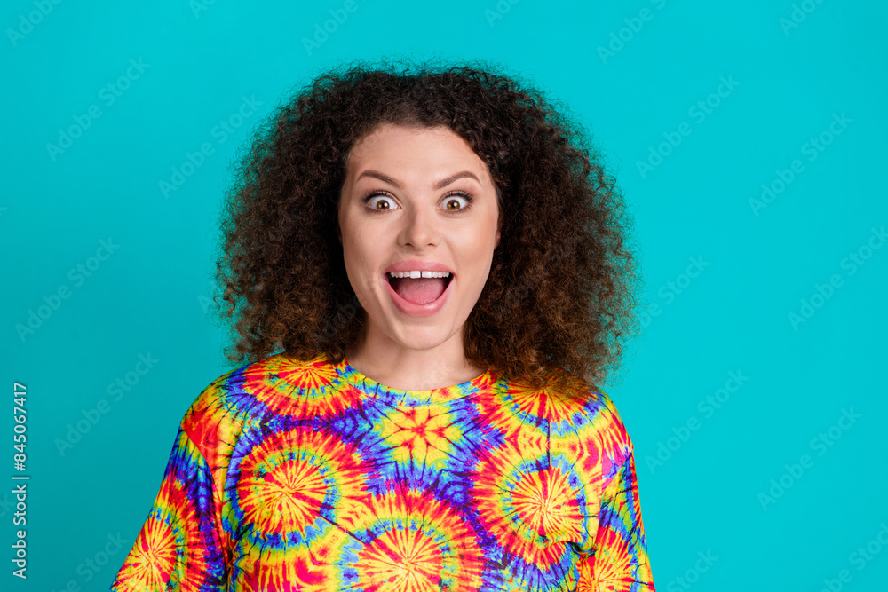 Photo of overjoyed glad lovely girl wear trendy vivid print clothes open mouth isolated on cyan color background Photo of overjoyed glad lovely girl wear trendy vivid print clothes open mouth isolated on cyan color background