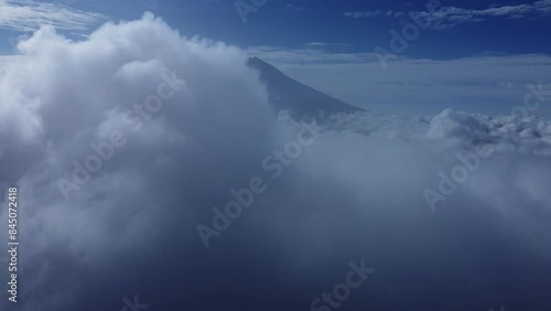 Aerial view of mountain with thick clouds. Thick white clouds covered the mountain peaks. Aerial view of Sumbing mountain, Java, Indonesia photo