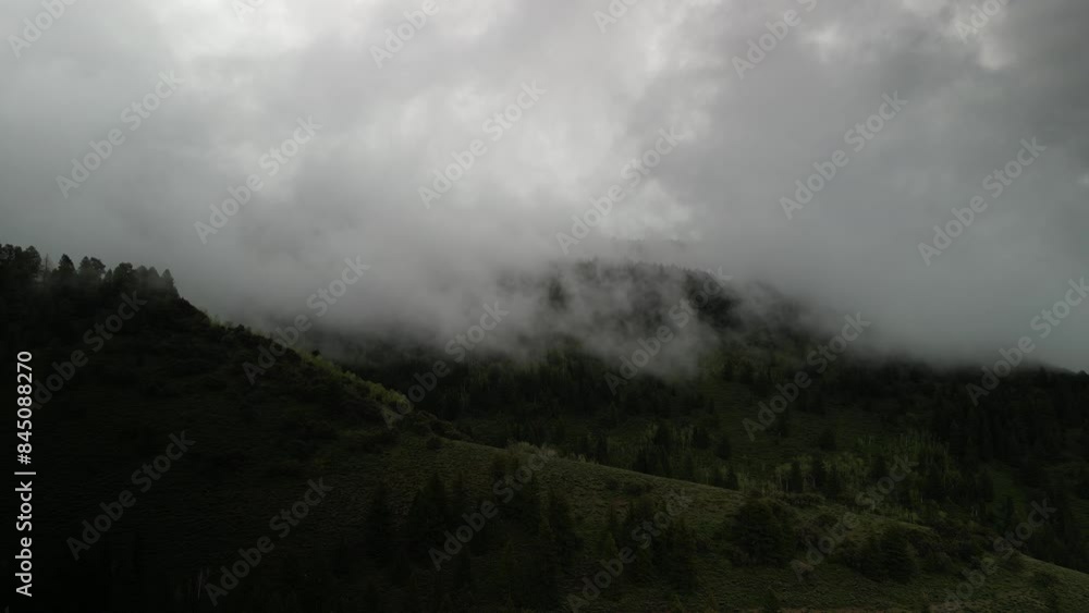 Aerial through low clouds in dark stormy forest in Northern utah in Logan Canyon Aerial through low clouds in dark stormy forest in Northern utah in Logan Canyon