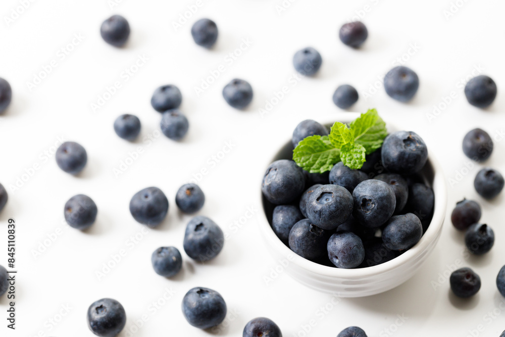 Ripe organic blueberries on white wooden table background. Selective focus. Ripe organic blueberries on white wooden table background. Selective focus.