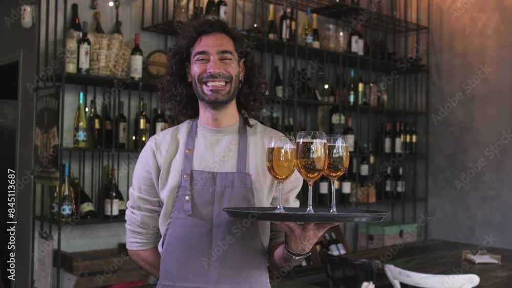 Happy waiter standing in bar holding tray of beer looking at camera. 4k resolution video. Happy waiter standing in bar holding tray of beer looking at camera. 4k resolution video.