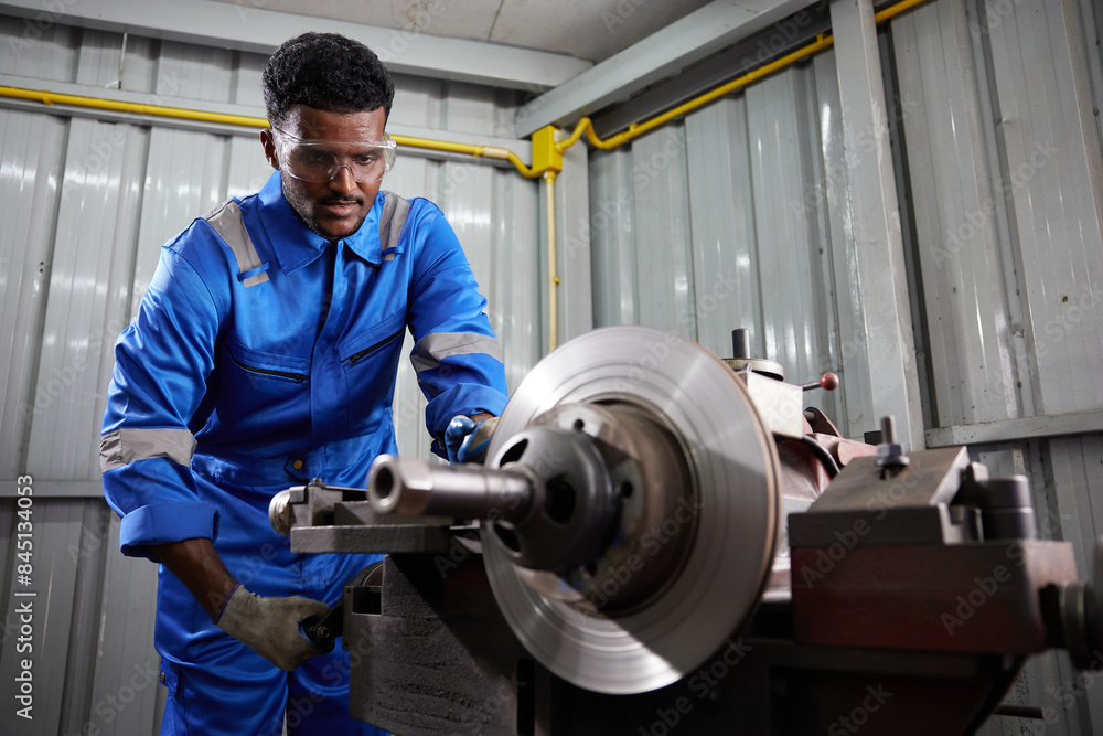 factory worker or technician working and control lathe machine in factory factory worker or technician working and control lathe machine in factory