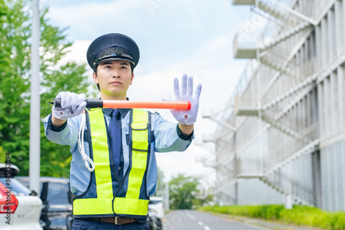 Фотография 交通誘導する警備員