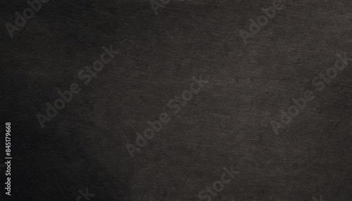 Handmade paper with a aged, rough, grainy, distressed texture in earthy dark black tones with visible fibers, art rustic backgrounds.