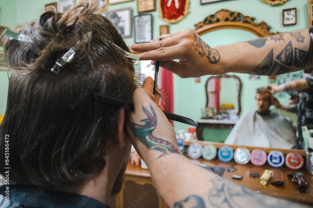 Fototapeta premium hairdresser cutting hair with scissors