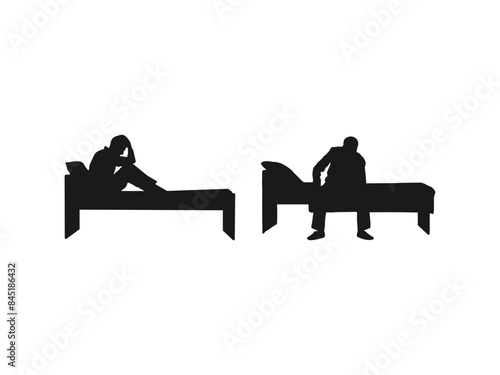 silhouette of a depressed man sadly sitting on the bed in the bedroom. sad man sitting on a single bed isolated on a white background.