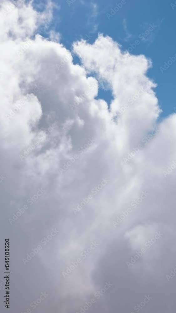 Vertical Screen: Capture the beauty of fluffy white clouds in vertical video against blue sky, perfect for aerial and nature projects. This 16x9 format showcases the scenic view and serene atmosphere Vertical Screen: Capture the beauty of fluffy white clouds in vertical video against blue sky, perfect for aerial and nature projects. This 16x9 format showcases the scenic view and serene atmosphere