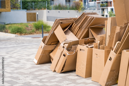 Pile of cardboard boxes ready for recycling outside a building
