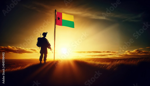 A soldier standing beside the Guinea-Bissau flag at sunset, symbolizing courage and dedication to the nation