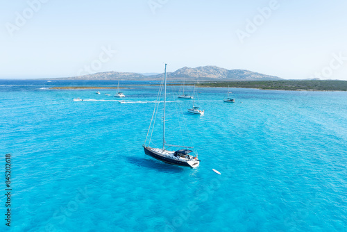 Summertime vacation. Drone view on the yacht. Sail yacht on the sea as a background. .Sea and waves from top view. Blue water background from top view. Top view from drone.