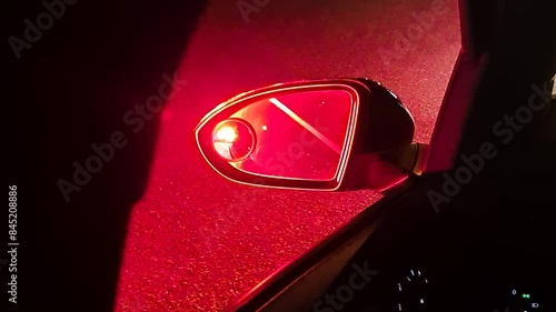 Police Emergency Lights in Rearview Mirror of Car at Night, Close Up