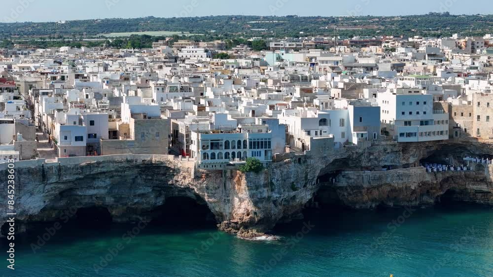 Cinematic Aerial View of Polignano A Mare: Picturesque Streets, Dramatic Cliffs, and Pristine Waters, Italy Cinematic Aerial View of Polignano A Mare: Picturesque Streets, Dramatic Cliffs, and Pristine Waters, Italy