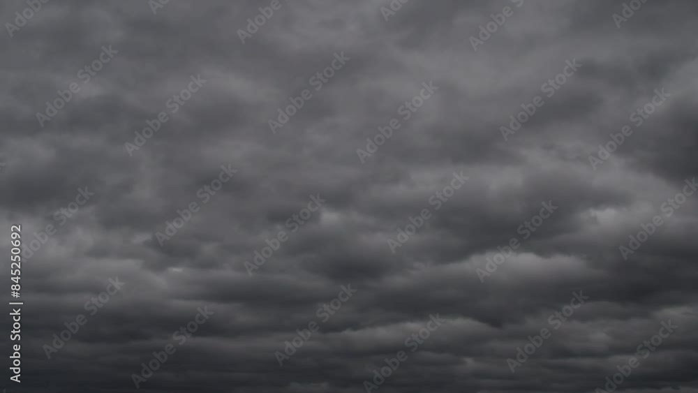 An ominous sky completely covered with dark clouds. Background with impending rain or storm. An ominous sky completely covered with dark clouds. Background with impending rain or storm.