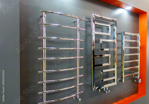 Heated towel rails with wall-mounted heating radiators with combined connections.