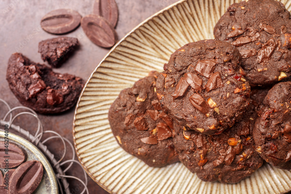 double chocolate cookies in ceramic plate on rusty background. double chocolate cookies in ceramic plate on rusty background.