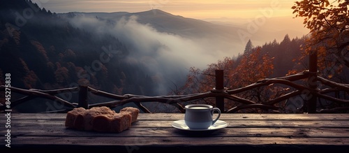An inviting Old wooden bench in the mountains serves as the perfect spot for a tray with a steaming mug of mulled wine creating a cozy copy space image photo