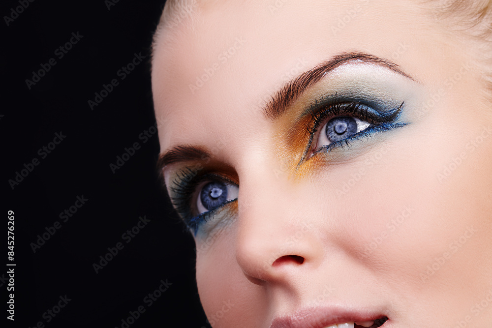Naklejka premium Woman, beauty and eyeshadow in studio, eyes and cosmetics for face on black background. Female person, color and creative skincare or foundation, self care and eyebrow treatment or dermatology shine