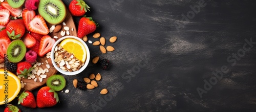 A healthy breakfast featuring a variety of nutritious foods like muesli a strawberry salad fresh fruit and nuts displayed on a grunge background This flat lay image showcases the concept of healthy e