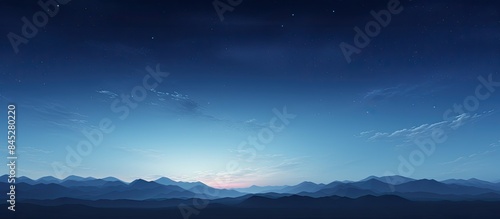 A picturesque panoramic scenery of a clear blue glowing sky during moonrise twilight and night representing concepts of meteorology heaven hope and peace Ideal for graphic resources and copy space im © HN Works