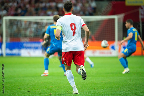 Soccer player with number 9 on his back during the match.