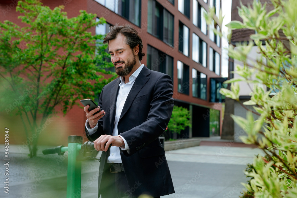 Businessman standing near electric scooter using smart phone at office park Businessman standing near electric scooter using smart phone at office park