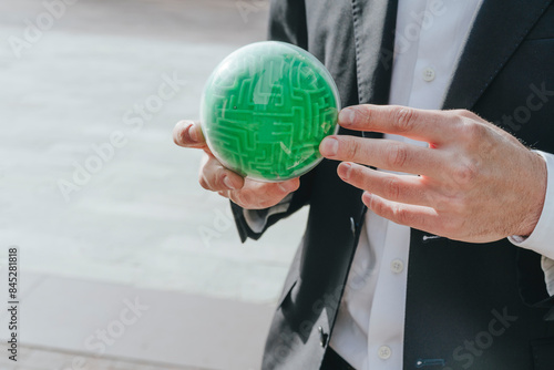Businessman solving green maze puzzle