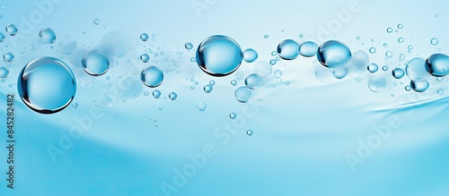A pastel blue background of cosmetic gel with bubbles dripping down creating an antibacterial liquid surface Ideal as a background or mockup with copy space for text or design in a top view perspecti