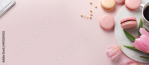 A stylish banner for a female blogger featuring a pink donut pink tulips and an open Notepad resting on a coffee background providing ample copy space