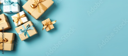 Convenient shopping made simple with sales and discounts A flat lay perspective from a high angle showcases a group of beautifully wrapped gift boxes tied with ribbons set against a blue background A photo