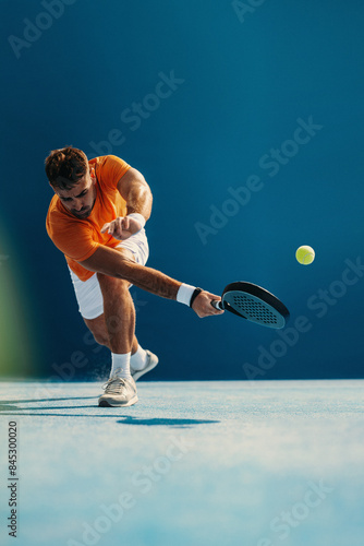 Padel athlete hitting a volley shot with skill and agility in a padel tennis game photo