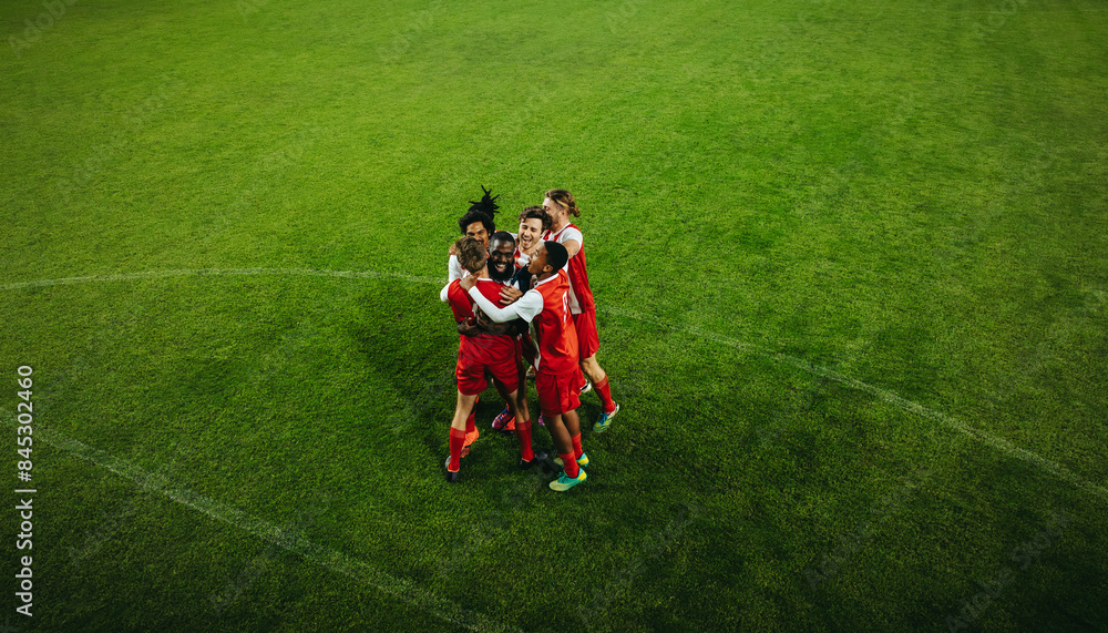 Football team celebrating victory on the field during a match Football team celebrating victory on the field during a match