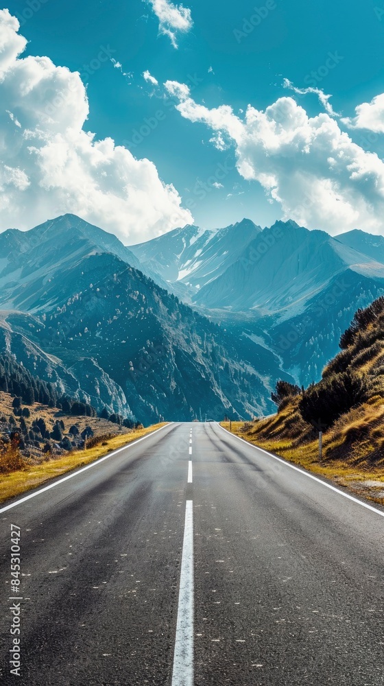 Naklejka premium Empty highway between mountain peaks, clear sunny day, incredible nature, bright saturated colors