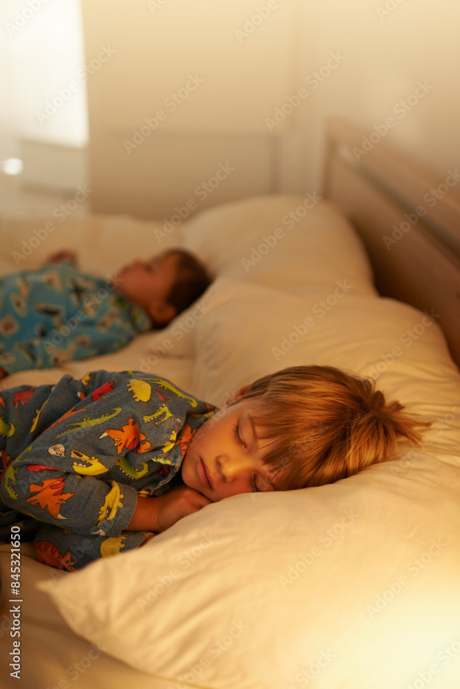 Children, bed and rest for night, sleeping and tired with fatigue and peace. Brothers, dreaming and exhausted with pyjamas, onesie and bedroom with lamp for serene childhood at home or house for kids Children, bed and rest for night, sleeping and tired with fatigue and peace. Brothers, dreaming and exhausted with pyjamas, onesie and bedroom with lamp for serene childhood at home or house for kids