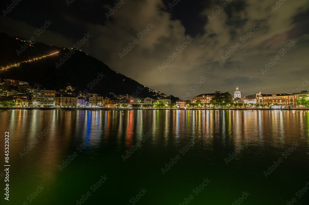 The city of Como, photographed in the evening, with the lakeside, the cathedral, the port and the moored boats. The city of Como, photographed in the evening, with the lakeside, the cathedral, the port and the moored boats.