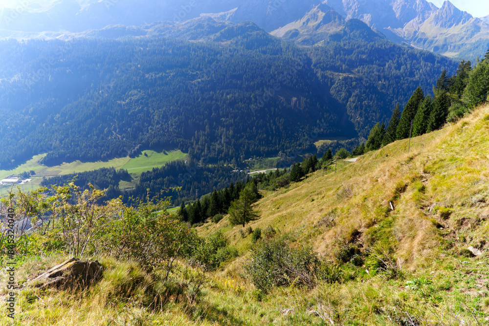 Fototapeta premium Scenic aerial view at mountain village of Airolo with Leventina Valley in the Swiss Alps on a sunny late summer day. Photo taken September 10th, 2023, Gotthard, Canton Ticino, Switzerland.