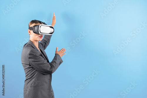 Smart business woman pointing to present idea while using VR goggles. Project manager wearing visual headset while connect in metaverse to access financial data.Technology innovation. Contraption. photo