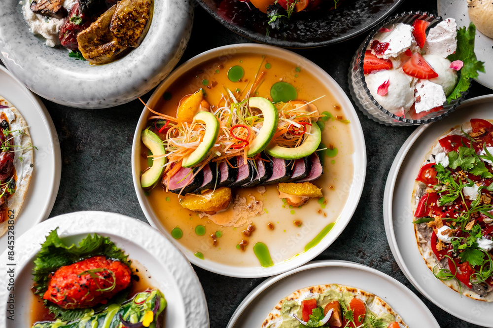 Variety of gourmet dishes with vibrant colors and diverse textures, arranged on a dark surface, suggesting a fine dining experience Variety of gourmet dishes with vibrant colors and diverse textures, arranged on a dark surface, suggesting a fine dining experience